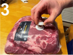 pork shoulder with cap being put on