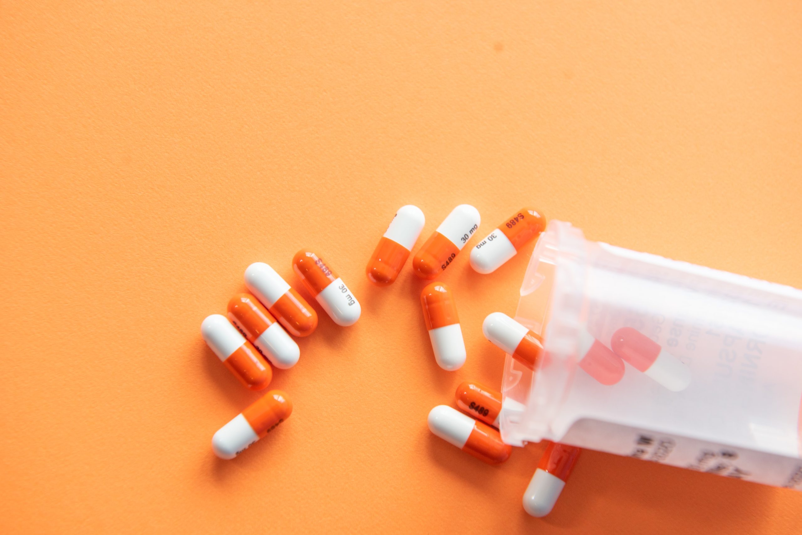 pill bottle with orange background.